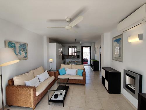 a living room with two couches and a tv at R1371 Capistrano Playa 417 in Nerja