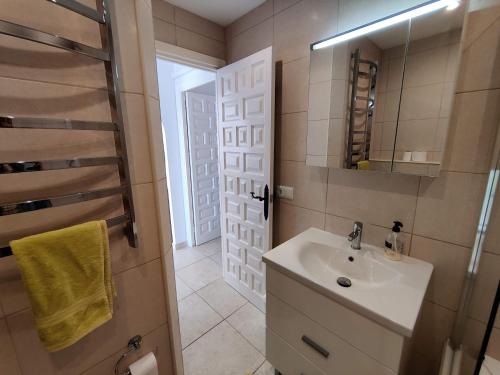 a bathroom with a sink and a mirror at R1371 Capistrano Playa 417 in Nerja