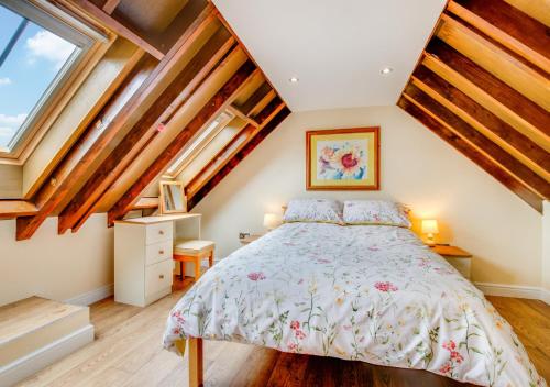 a bedroom with a bed in a attic at Ysgubor Wen in Llanrwst