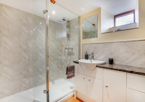 a bathroom with a shower and a sink at Ysgubor Wen in Llanrwst
