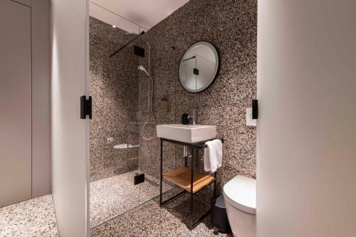 a bathroom with a sink and a mirror at Gozo Harbour Views, Mgarr Heights in Mġarr