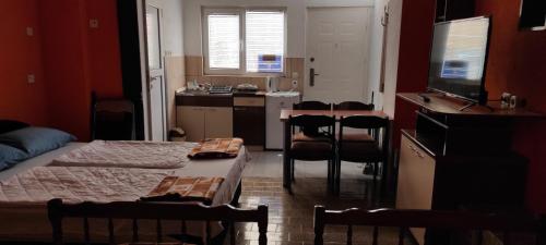 a room with two beds and a table and chairs at Apartment Sekulovski in Ohrid