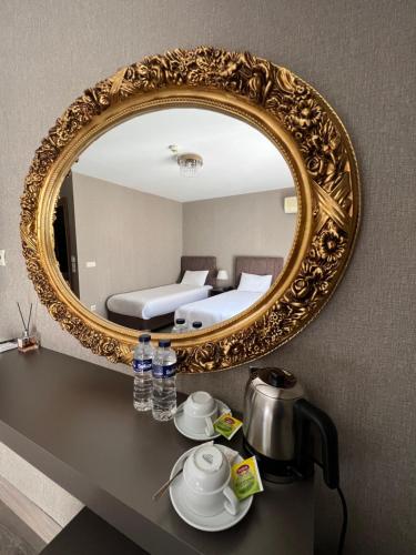 a gold mirror on a wall with a bed in a room at Flower Palace Hotel in Istanbul