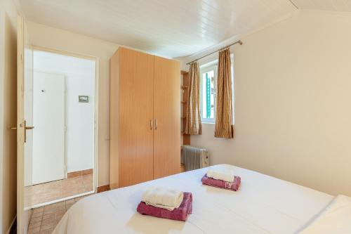 a bedroom with a bed with two towels on it at Detached Villa with stunning views in Njivice, Montenegro in Njivice