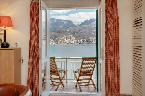 a balcony with chairs and a view of the water at Detached Villa with stunning views in Njivice, Montenegro in Njivice