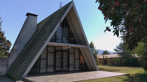 a small house with a triangular roof at Serenity Graskop, 3 bedroom A-Frame cottage in Graskop