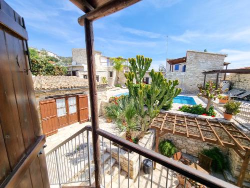 a view from the balcony of a house with a swimming pool at Aphrodite's Pool Retreat in Skarinou