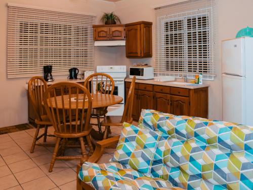 a kitchen with a couch and a table with chairs at Kiskadee Korner Vacations in Buccoo