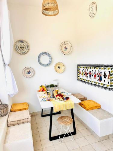 a dining room with a table and chairs and plates on the wall at Casa Molo 13 in Mattinata