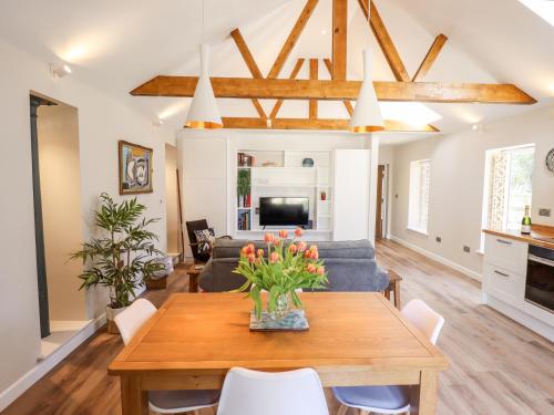 a living room with a table and a couch at The Asparagus Shed in Sleaford