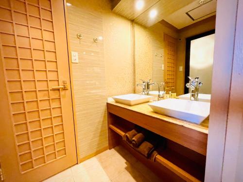 a bathroom with a sink and a mirror at 嵐 Hotel Arashi 心斎橋店 in Osaka