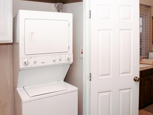 a white washer and dryer in a kitchen at Kiskadee Korner Vacations in Buccoo