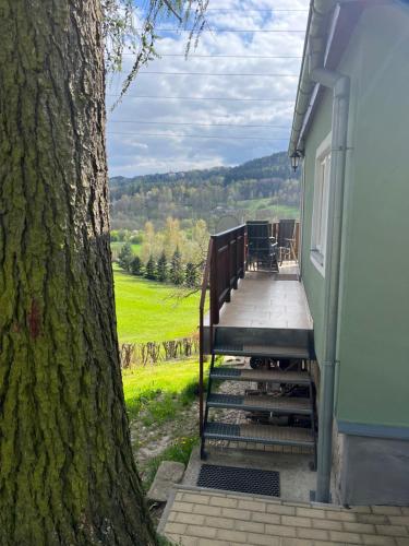 a staircase leading up to a house next to a tree at Chata Michaela in Turnov