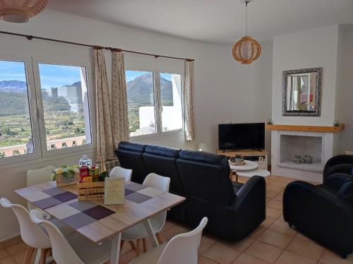 a living room with a table and chairs and a couch at Vakantiewoning CasaLucka4enjoy private pool and mountain view regio Calpe-Jalon in Jalón