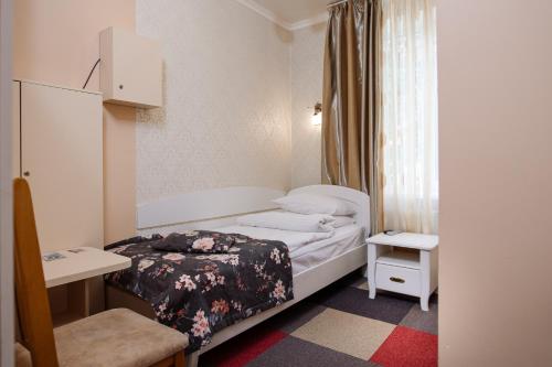 a small room with a bed and a window at Na Horyzonti in Truskavets