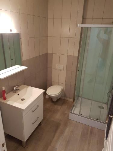 a bathroom with a toilet and a sink and a shower at Centre Mansle in Mansle