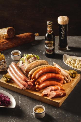 a tray of sausages and other foods on a table at Daeha Serviced Apartment in Hanoi