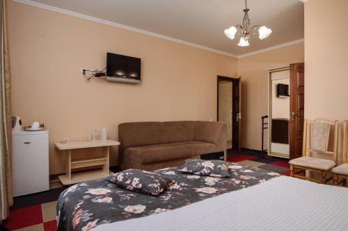a hotel room with a bed and a couch at Na Horyzonti in Truskavets