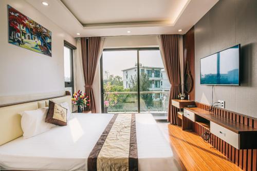 a bedroom with a large bed and a large window at Villa FLC Sầm Sơn in Sầm Sơn