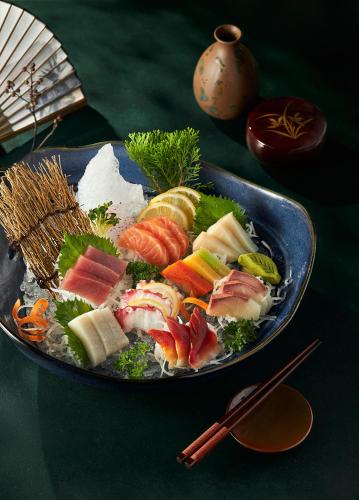 a plate of food with sushi on a table at Daeha Serviced Apartment in Hanoi