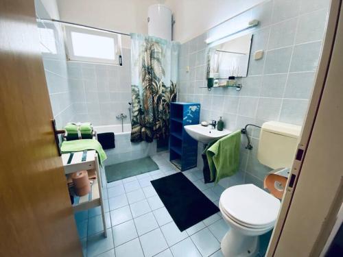 a bathroom with a toilet and a sink at Pet-friendly two-room family apartment in magical Bale in Bale