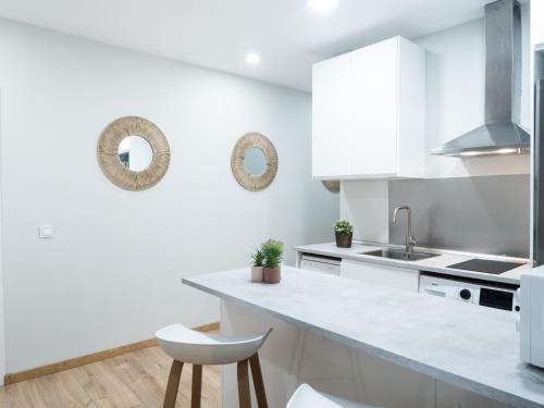 a white kitchen with a sink and a counter at Almar Collection Atocha in Madrid