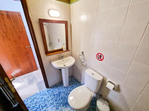 a bathroom with a toilet and a sink at Aphrodite's Pool Retreat in Skarinou