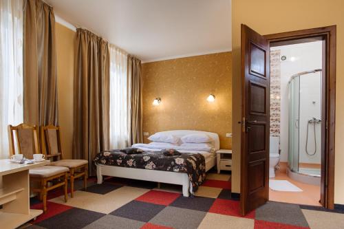 a hotel room with a bed and a bathroom at Na Horyzonti in Truskavets