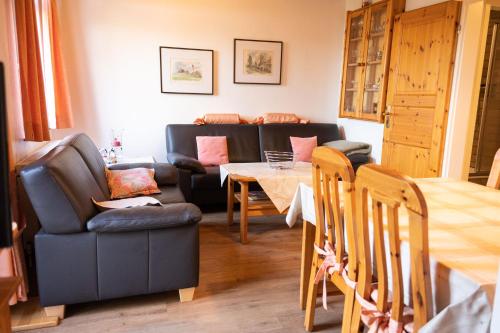 a living room with a couch and a table at Sophienmühle II Nähe Carolinensiel in Wangerland