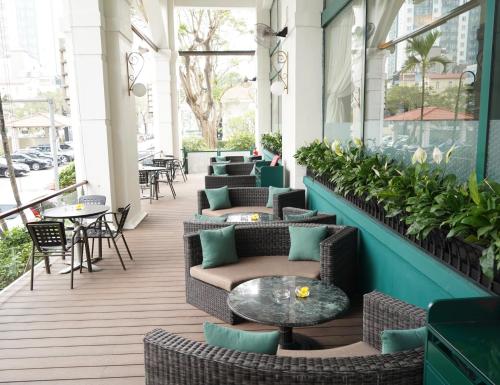 a patio with couches and tables and chairs at Daeha Serviced Apartment in Hanoi