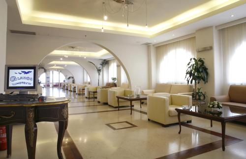 a lobby with a waiting room with couches and tables at Glaros Beach Hotel in Hersonissos