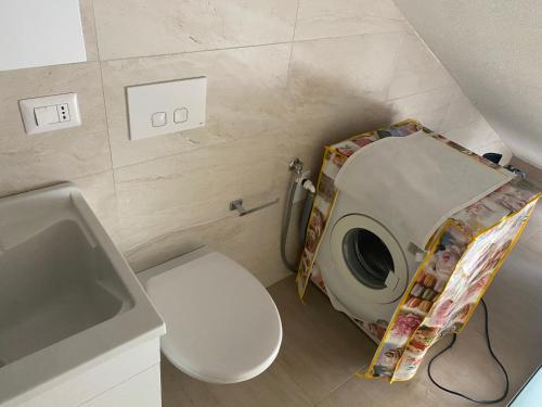a small bathroom with a toilet and a sink at TOT apartment in Policoro