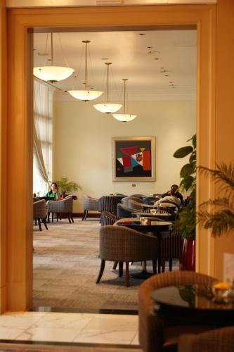 a lobby with tables and people sitting in chairs at Daeha Serviced Apartment in Hanoi