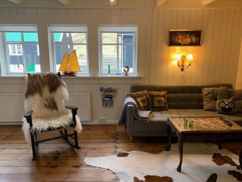 a living room with a couch and a chair at The Old Store in Hellur