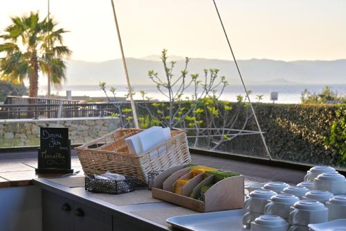 a table with baskets of food on a balcony at Résidence Les Calanques in Ajaccio