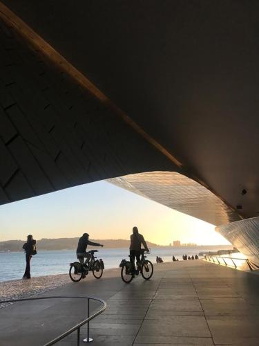a group of people riding bikes on the beach at Beach & City - Trafaria in Trafaria