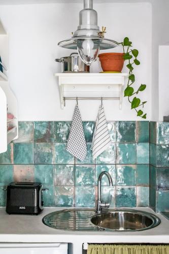 a kitchen with a sink and a counter top at Cath's Loft in Skopelos Town