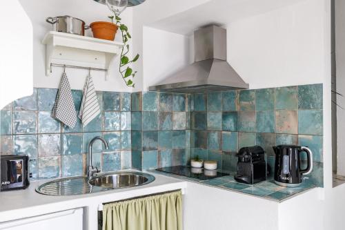 a kitchen with a sink and a stove at Cath's Loft in Skopelos Town