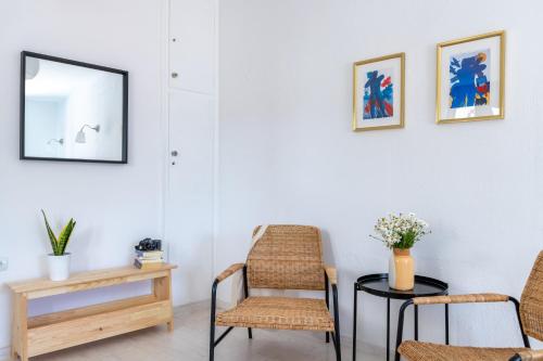 a room with chairs and a table and a mirror at Cath's Loft in Skopelos Town