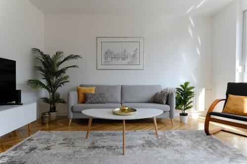 a living room with a couch and a coffee table at Apartment Skopljak + free garage in Sarajevo