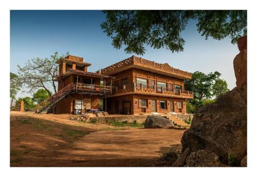a large brick building with a tower on top of it at Chandera Kothi in Orchha