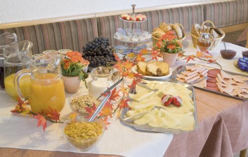 a table with a buffet of food and drinks at Pension Schwaiger in Bad Gögging