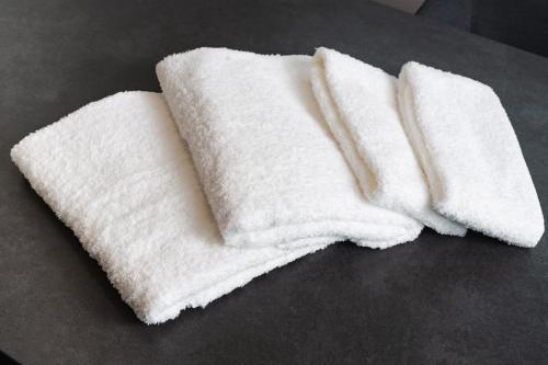 a pair of white towels sitting on a table at 郷音 ～G.O.A.T～ in Tsuru 