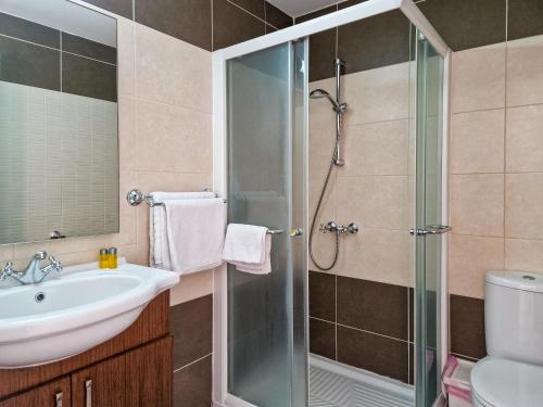 a bathroom with a sink and a shower at Sanders Village in Vasa Kilaniou