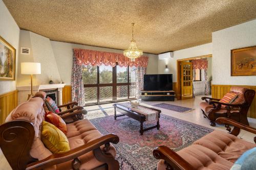a living room with a couch and a tv at WHome Perfect Family Hideout Residence w/AC & 4BR + 5BA in Cascais