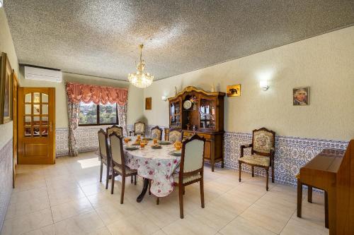 a dining room with a table and chairs at WHome Perfect Family Hideout Residence w/AC & 4BR + 5BA in Cascais