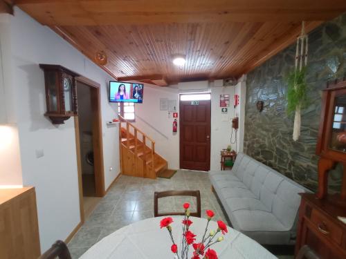 a living room with a couch and a table at Casa Rústica da Lavandeira in Valongo dos Azeites