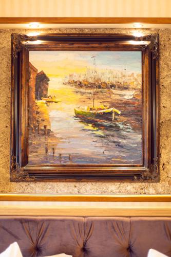a painting of a harbor with boats in the water at Hotel Am Ring in Sibiu
