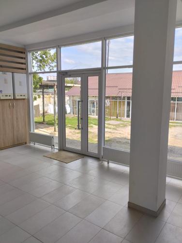 an empty living room with sliding glass doors at PARK-hotel in Cahul