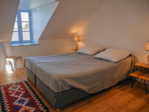 a bedroom with a bed with two pillows on it at Maison Sauzon, 5 pièces, 8 personnes - FR-1-418-201 in Sauzon